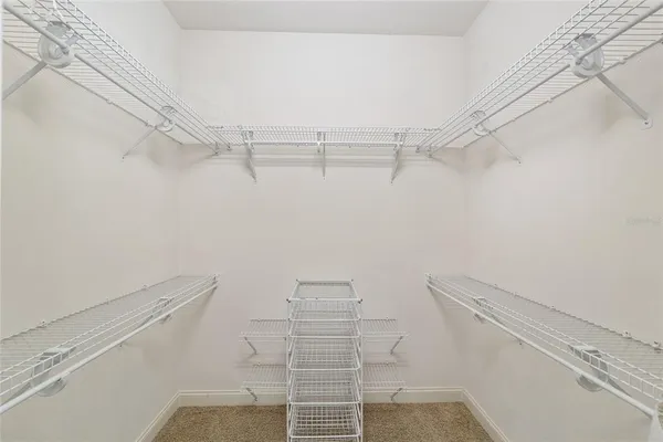 a spacious bathroom with a tub sink and mirror