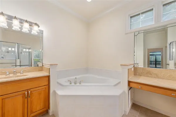 a spacious bedroom with a bed and a chandelier