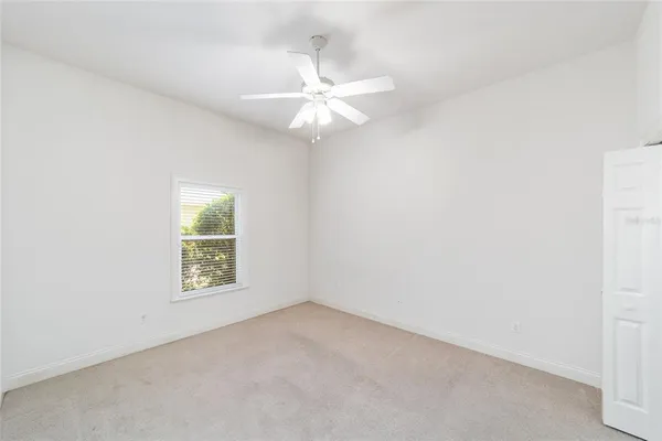 an empty room with a empty shelves and natural light