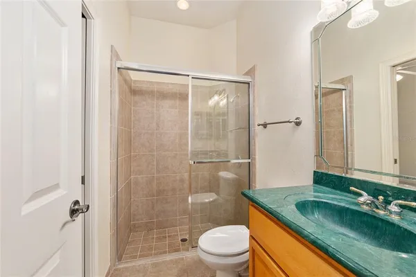 a dining room with a glass top table and chairs