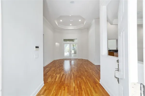 a view of wooden floor and windows in a room