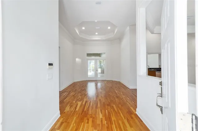 a view of wooden floor and windows in a room