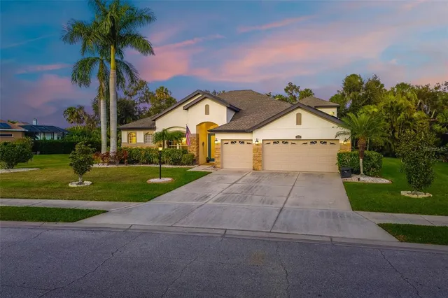 a front view of a house with a yard and garage