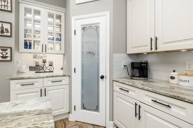 a bathroom with a toilet a sink a mirror a window and vanity