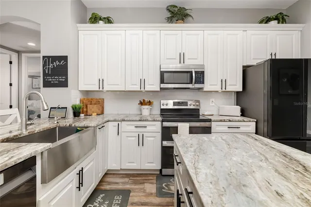 a bedroom with a bed table and a window