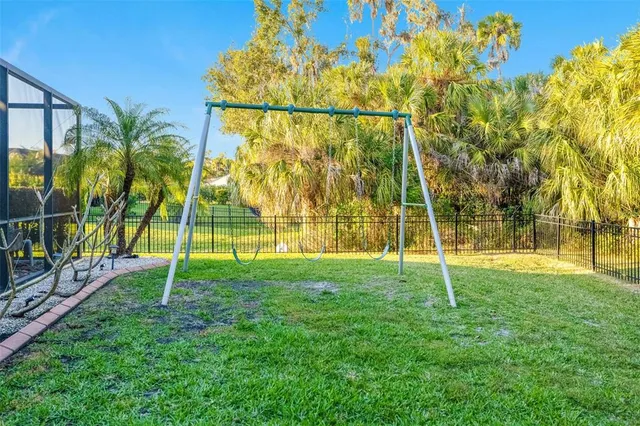 a view of a house with a yard and potted plants