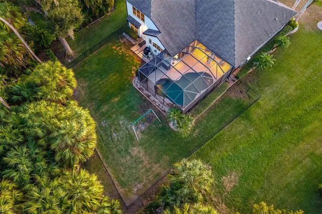 an aerial view of residential house with outdoor space and parking
