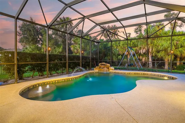 an aerial view of a house with a swimming pool
