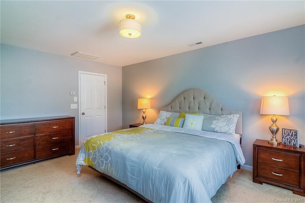 2187 Durand Road Fort Mill, SC 29715 - Photo 14 of 24 a bedroom with a bed and a lamp on dresser