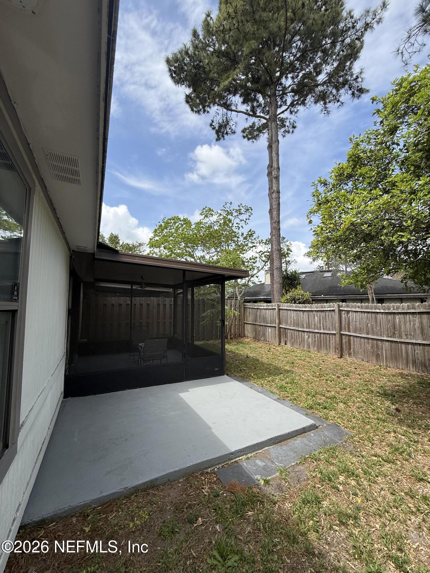 2360 Bitternut Way Jacksonville, FL 32246 - Photo 23 of 26 a view of balcony with a floor to ceiling window and wooden fence