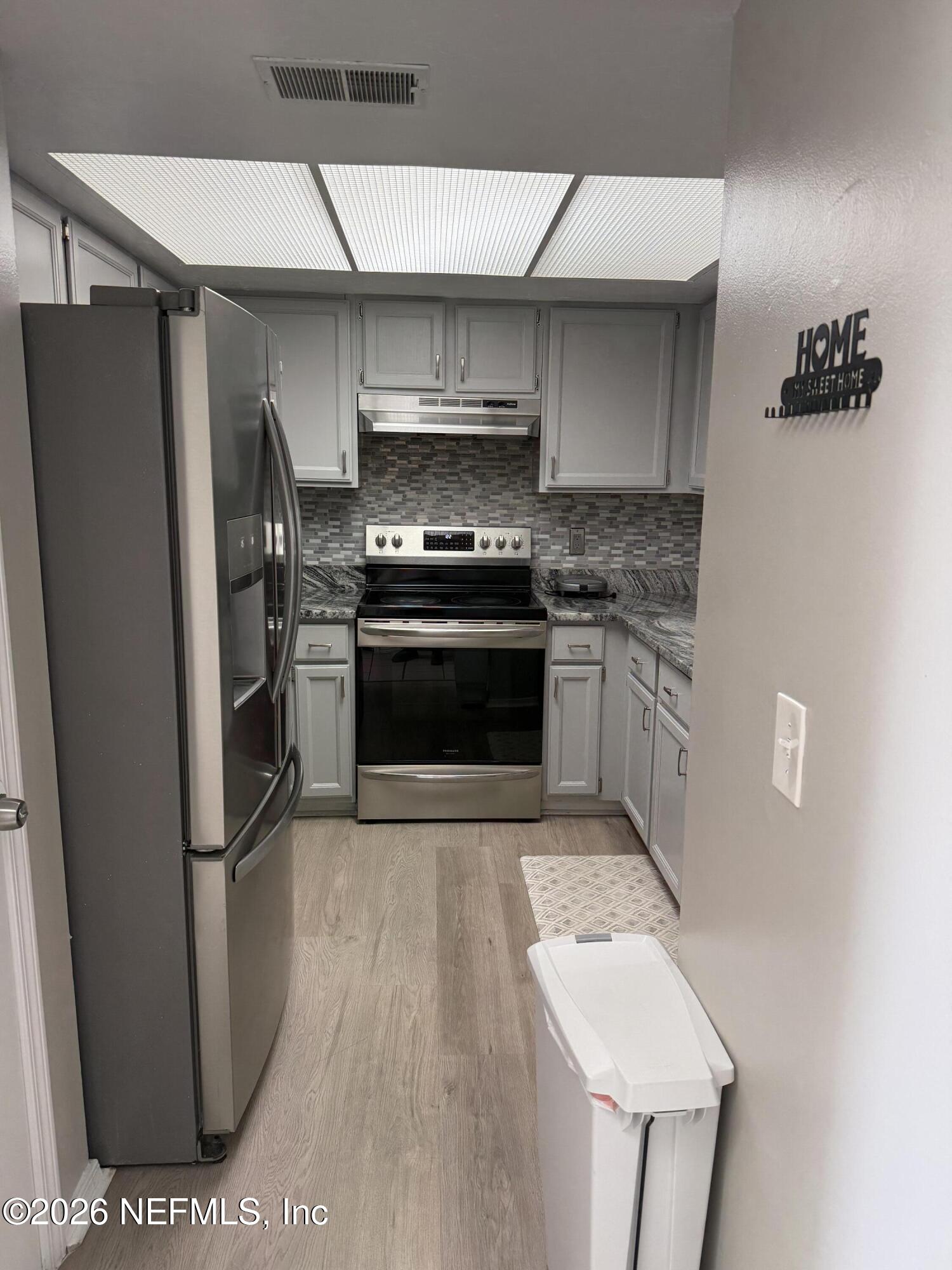 2360 Bitternut Way Jacksonville, FL 32246 - Photo 5 of 26 a kitchen with stainless steel appliances granite countertop a refrigerator a stove and a sink