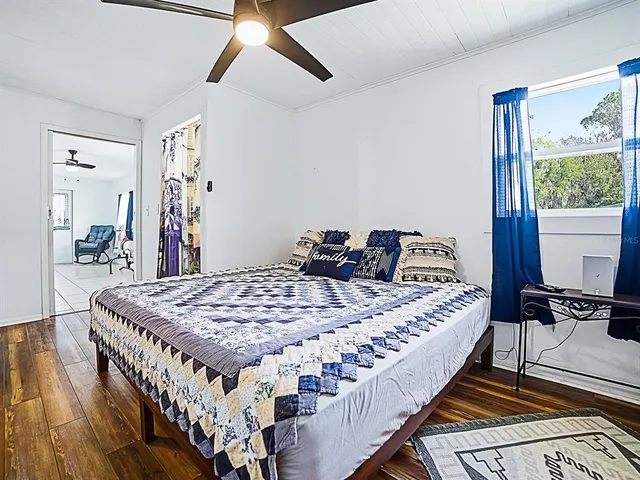 a bed sitting in a bedroom next to a window