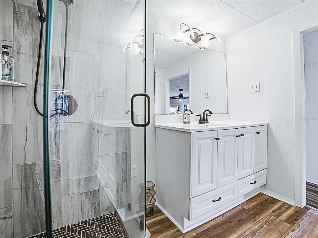 211 Rue De Paresse Tavares, FL 32778 - Photo 15 of 27 a bathroom with a sink and a mirror