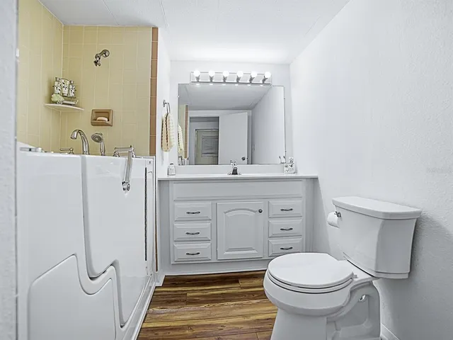 a bathroom with a sink a mirror and a toilet