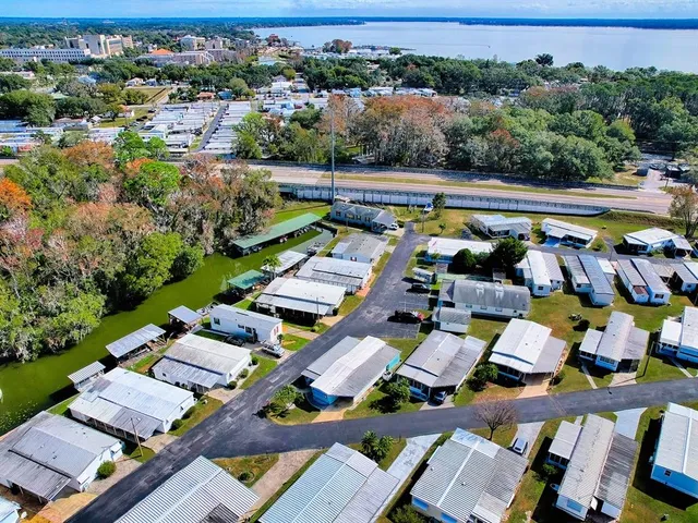 an aerial view of a swimming pool patio and outdoor seating