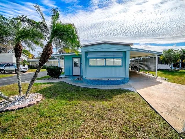 a view of a house with a swimming pool and a yard