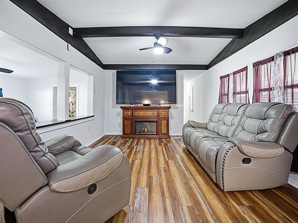 211 Rue De Paresse Tavares, FL 32778 - Photo 3 of 27 a living room with furniture and a fireplace