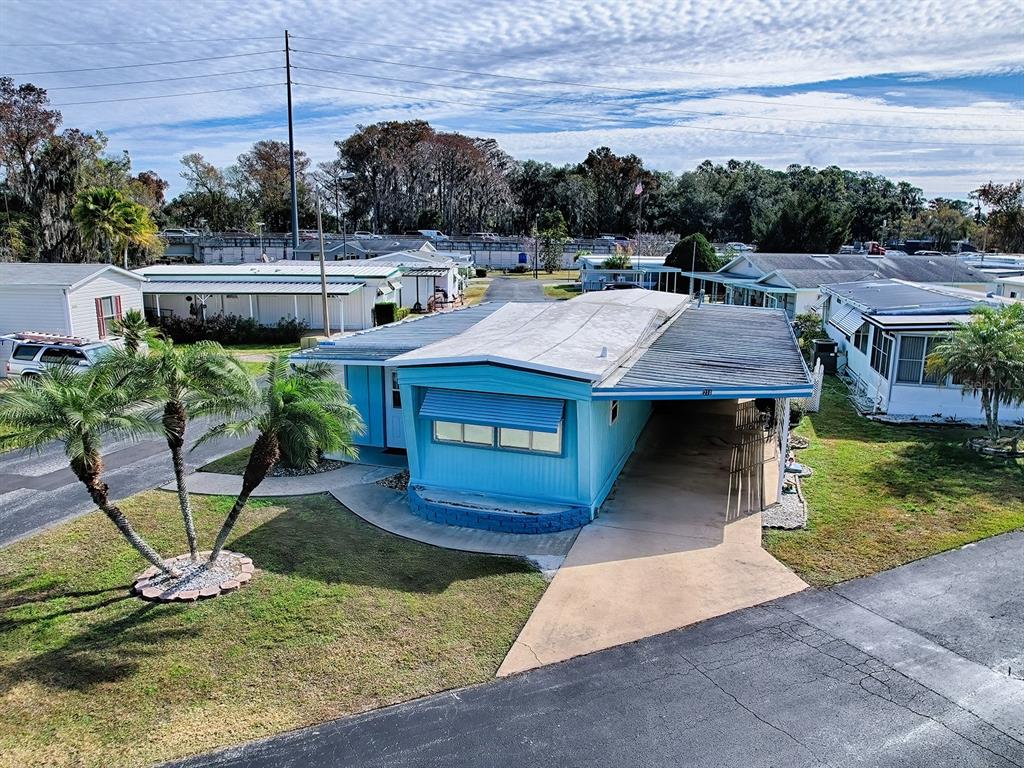 211 Rue De Paresse Tavares, FL 32778 - Photo 7 of 27 a view of a swimming pool with a yard