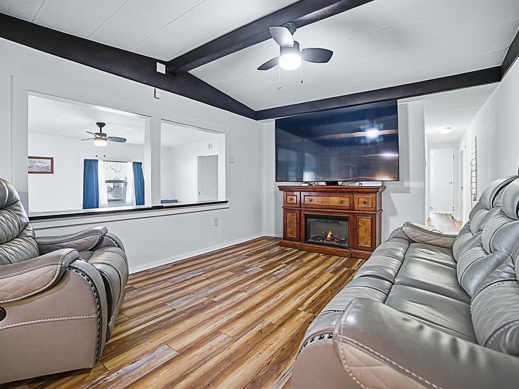 211 Rue De Paresse Tavares, FL 32778 - Photo 10 of 27 a living room with furniture and a chandelier