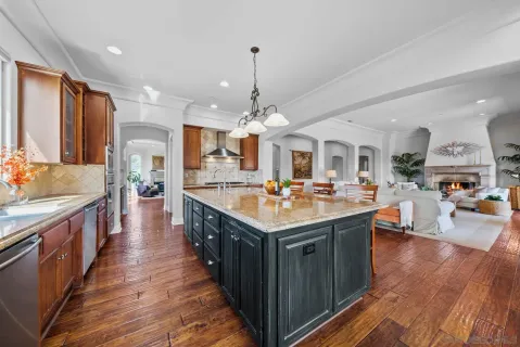 a kitchen with stainless steel appliances granite countertop lots of counter top and stove