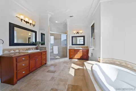 a spacious bathroom with a granite countertop sink mirror and bathtub