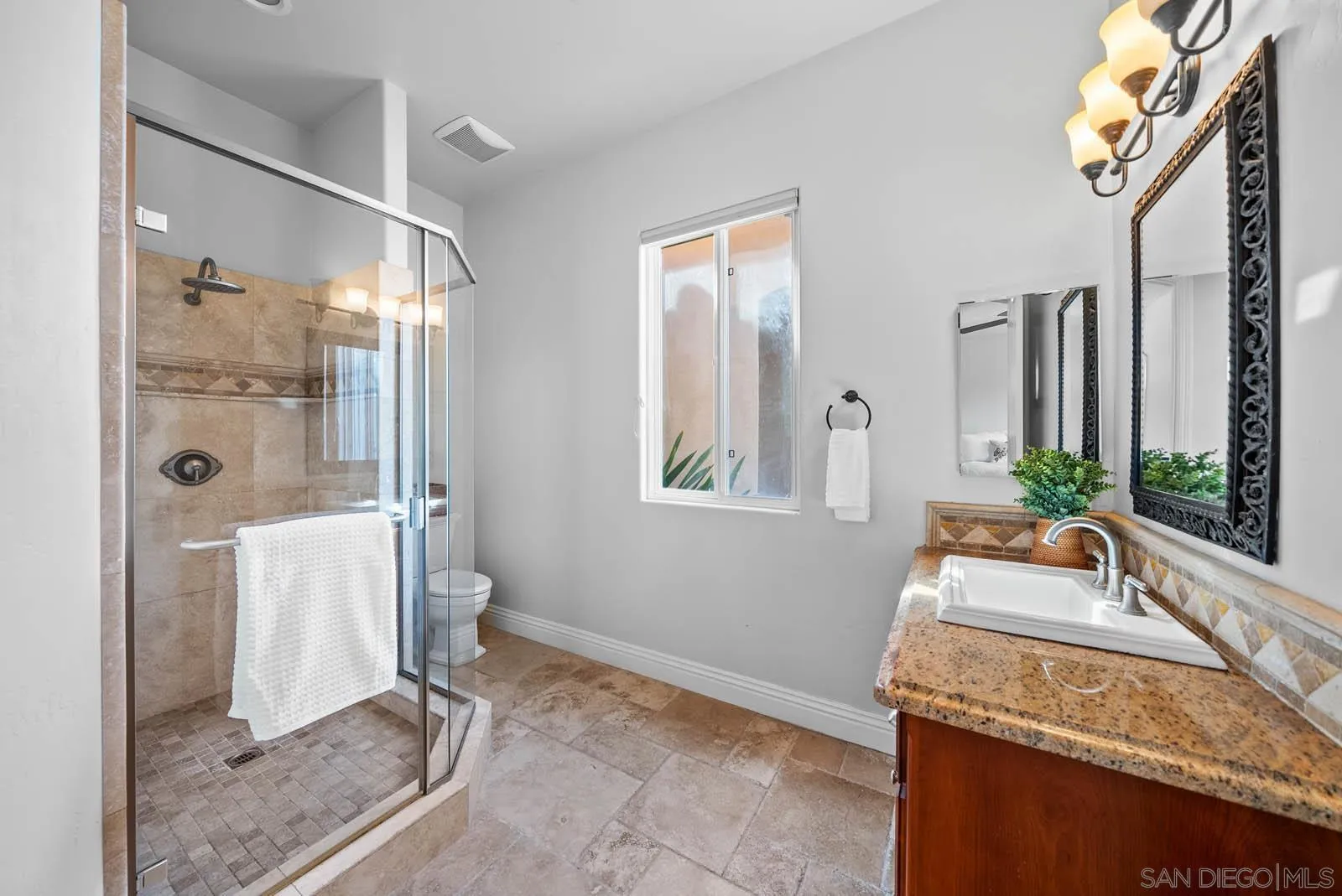 2247 Margarita Glen Fallbrook, CA 92028 - Photo 24 of 40 a bathroom with a granite countertop sink and a mirror