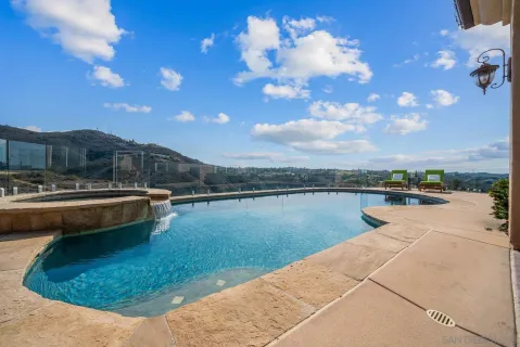 a view of a house with a yard and potted plants