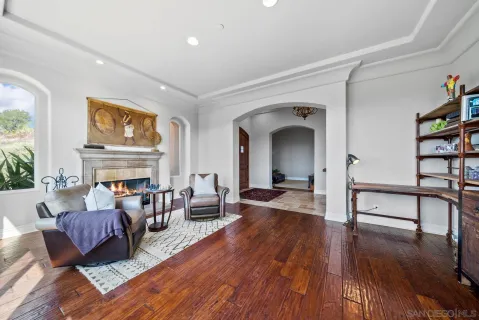 a living room with fireplace furniture and a wooden floor