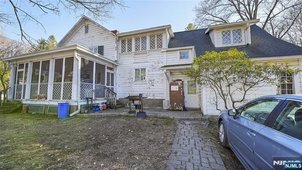 a view of a dining room with furniture a chandelier and wooden floor