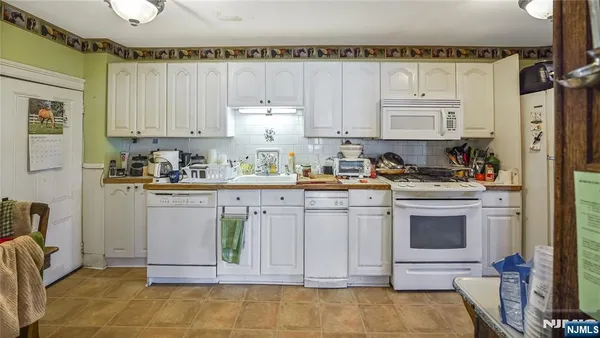 a living room with furniture and a book shelf
