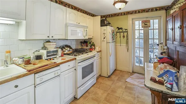a spacious bedroom with a bed and a flat screen tv
