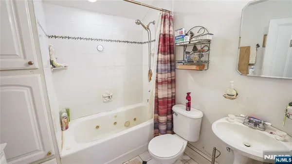 a bedroom with a bed and a table in it with window