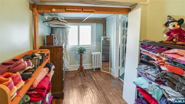 a bedroom with furniture and a window