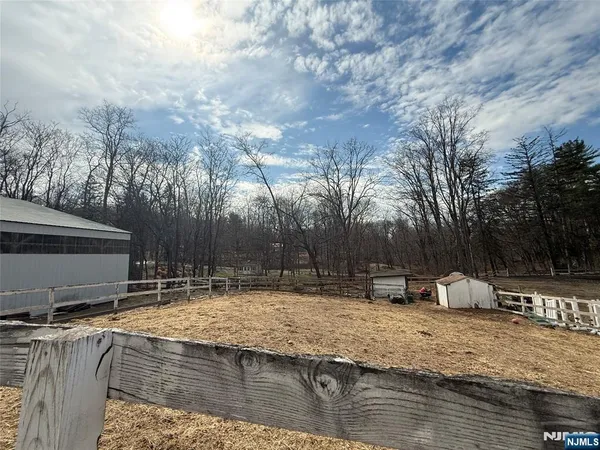 a view of a house with a yard and pathway