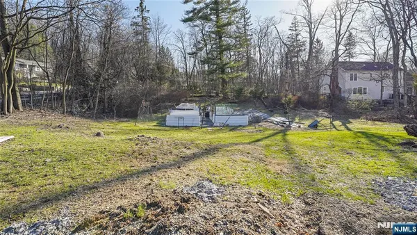 a view of swimming pool with outdoor seating and covered with trees