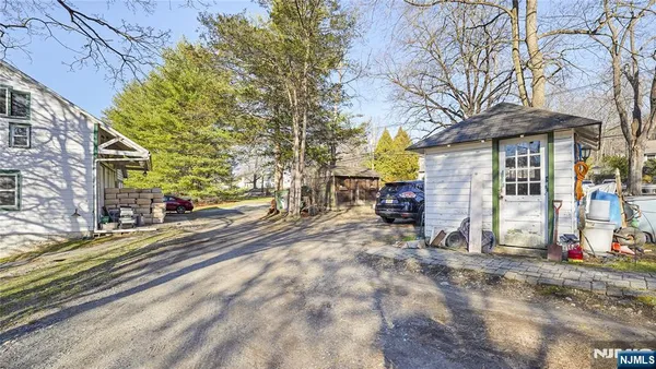 a kitchen with stainless steel appliances granite countertop a refrigerator a sink dishwasher and white cabinets next to a window