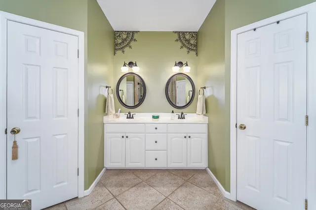 a view of bathroom with dual sinks