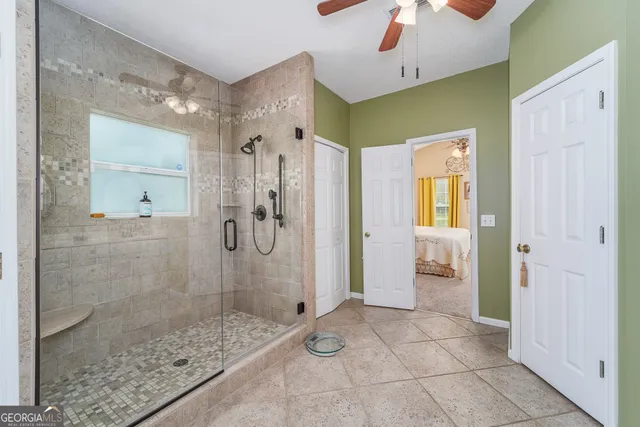 a bathroom with a glass door shower