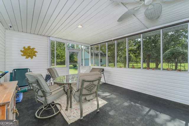 a view of a dining room with furniture window and outside view