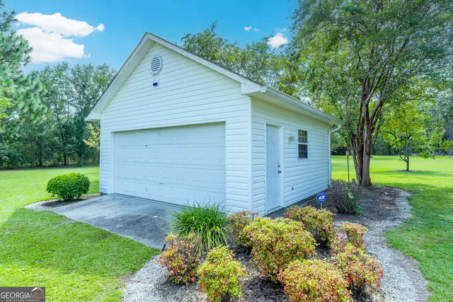 a view of a small house with a yard