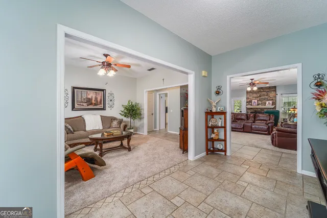 a living room with furniture and a dining table