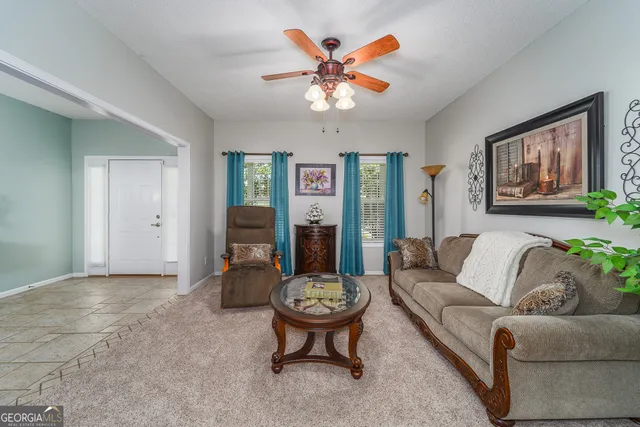 a living room with furniture and white walls