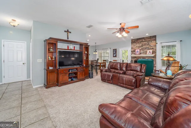 a living room with furniture and a flat screen tv