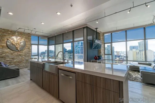 a large kitchen with lots of counter space and glass windows
