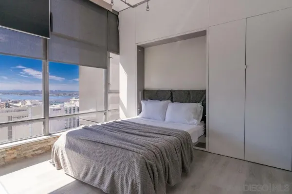 a bed sitting in a bedroom next to a window