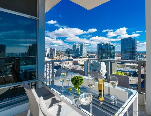 a dining room with furniture and a floor to ceiling window
