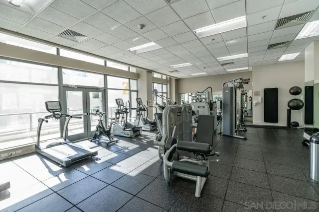 a living room with lots of furniture and glass door
