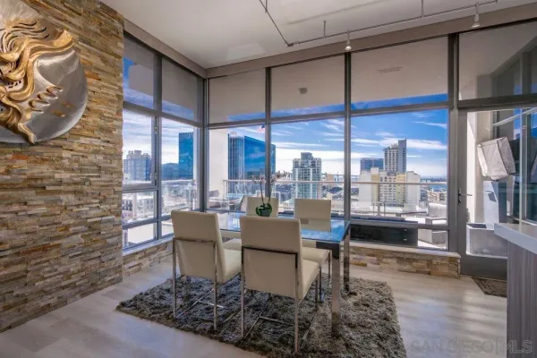 a living room with furniture and a floor to ceiling window