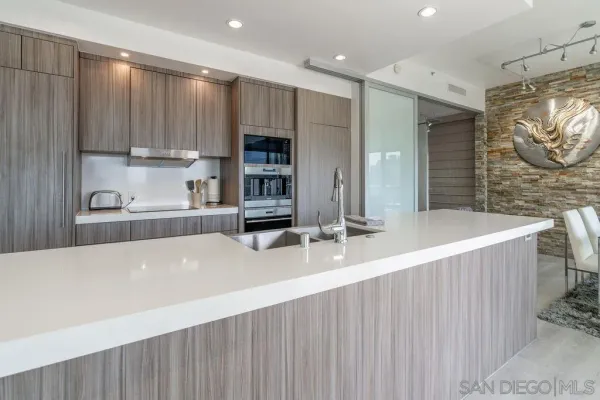 a large kitchen with kitchen island a sink stainless steel appliances and cabinets