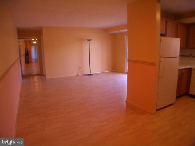 12007 Tarragon Road, Unit 12007 Reisterstown, MD 21136 - Photo 5 of 10 a view of an empty room with a kitchen